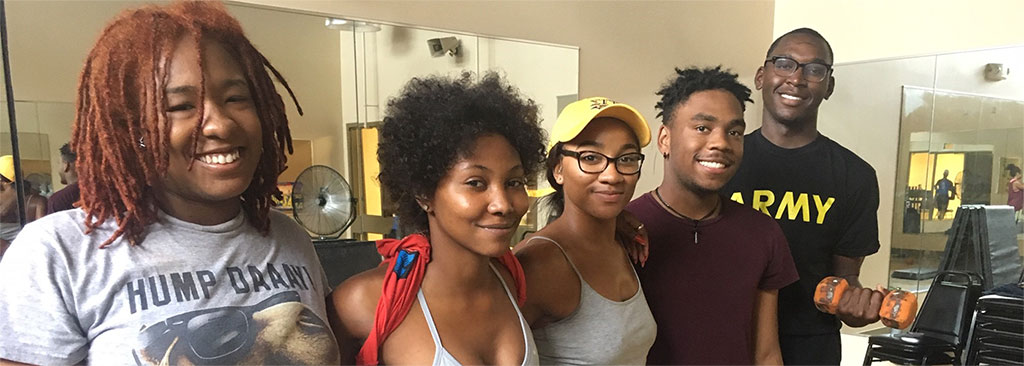 Five smiling students pose for a picture after a fitness class at the Student Health & Wellness Center